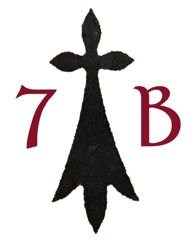 A broad-based black cross symbol is centred between a red "7" on the left and a red "B" on the right. The background is transparent.